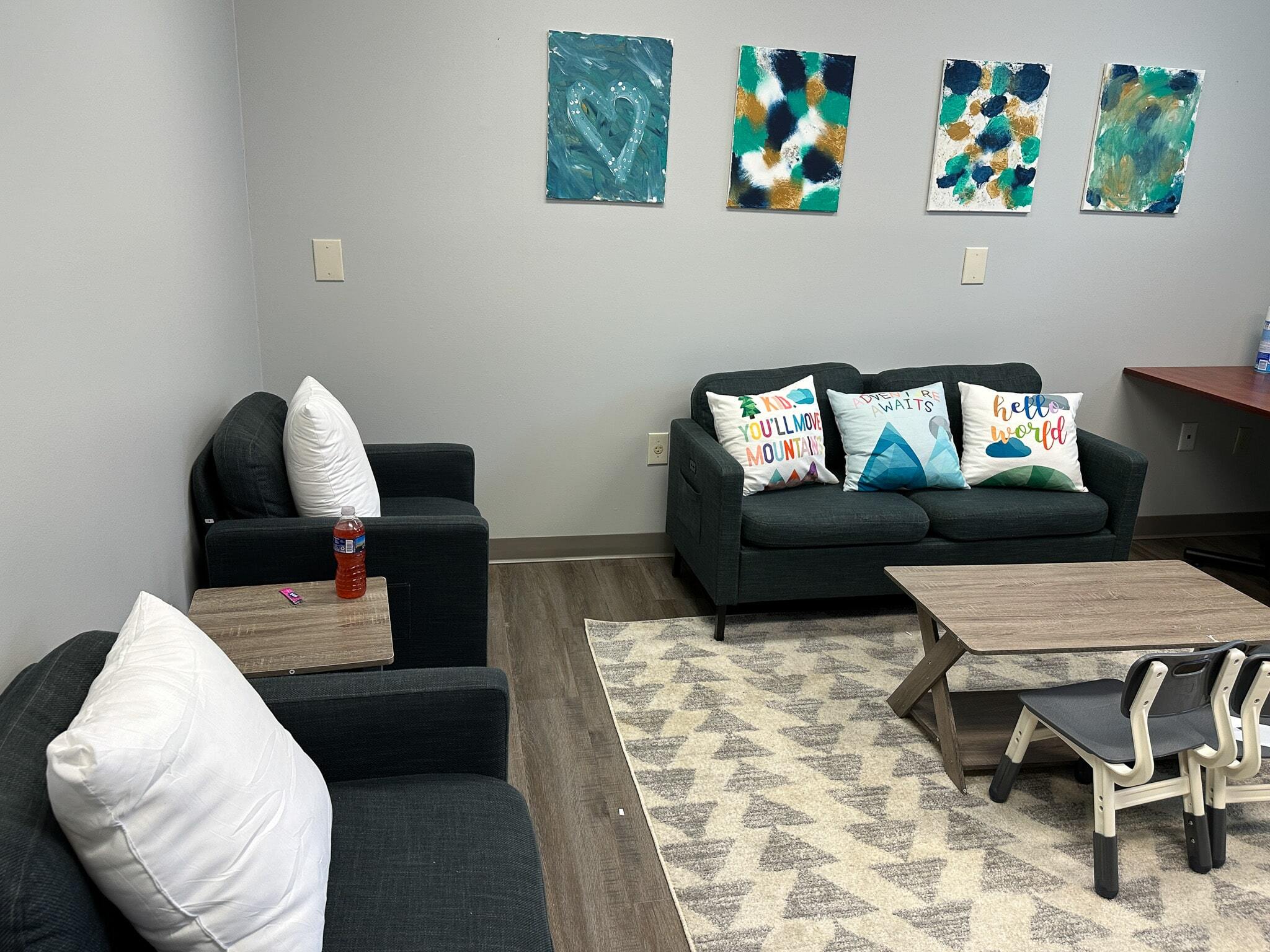 Comfortable couches and a rug in the teen lounge area at the Christiansburg ABA Center