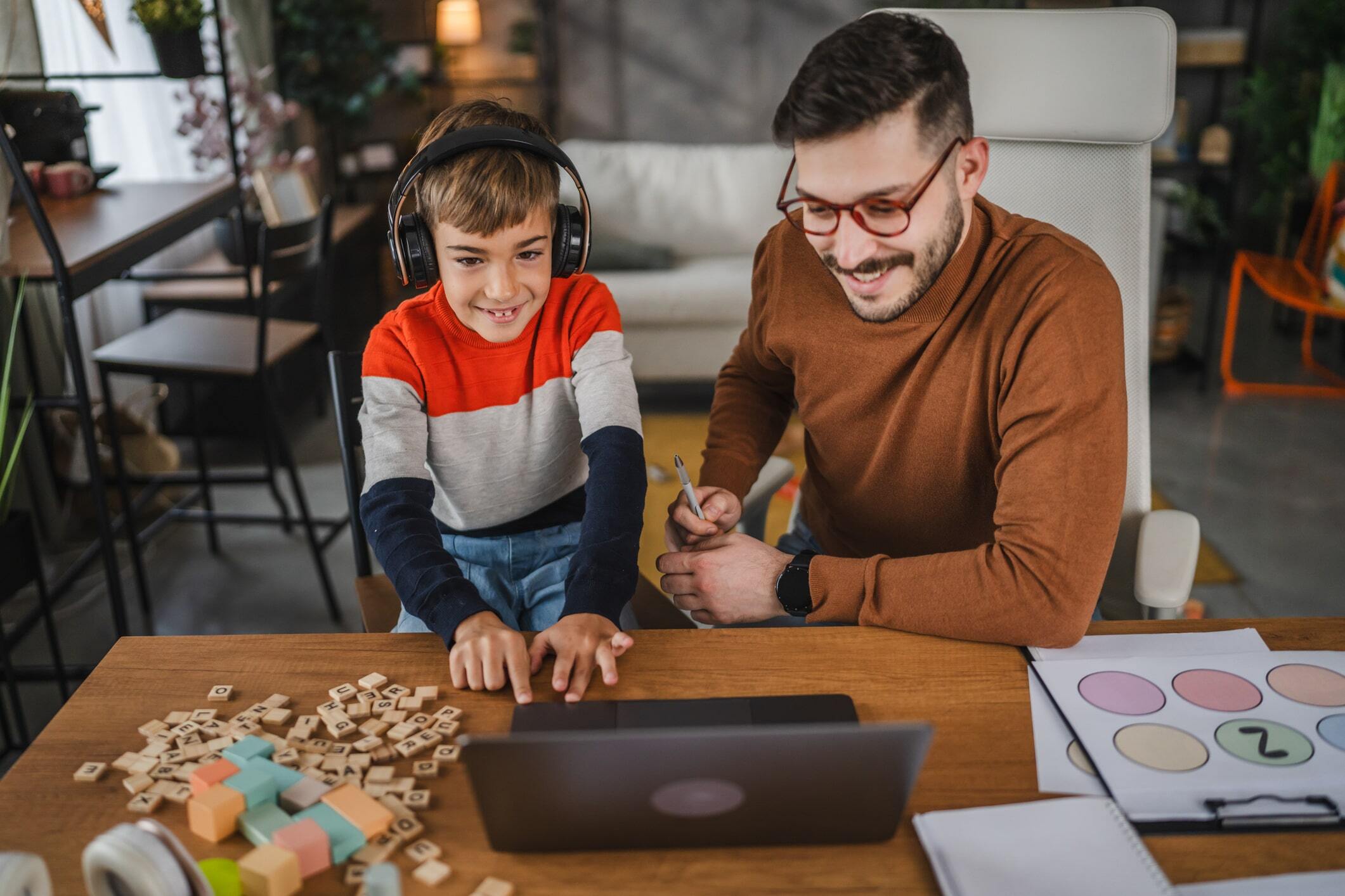 Caregiver and child looking at a computer