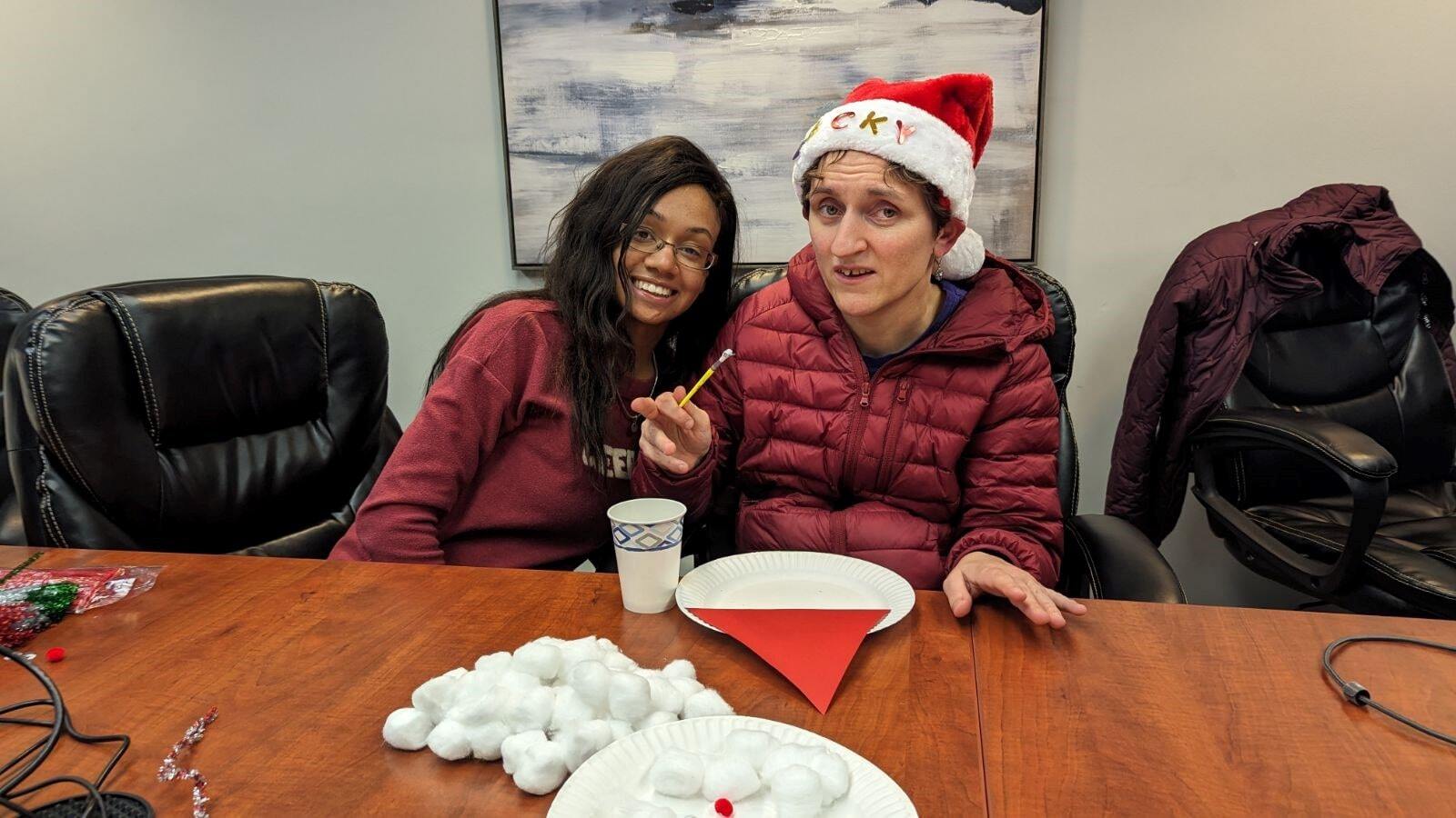 Caregiver and client making Christmas decorations